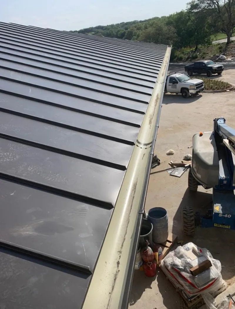 Standing seam panel and gutter detail on a metal roofing jobsite in Birdsboro